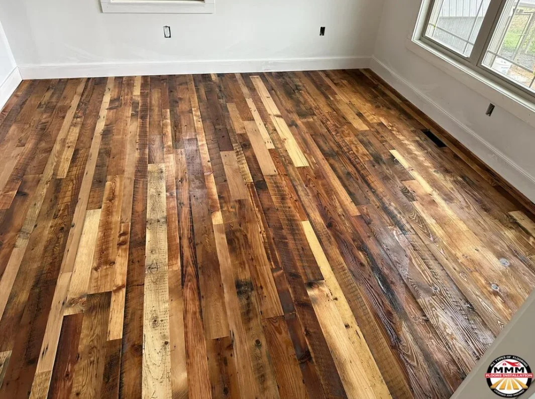 Random-width hardwood flooring in mixed brown and amber tones with natural grain patterns