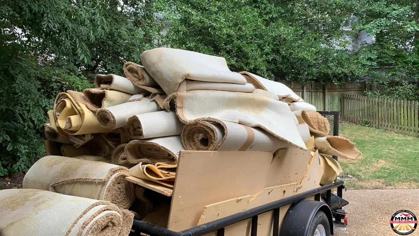 Rolled carpet and jute-backed underlayment stacked on flatbed trailer for delivery